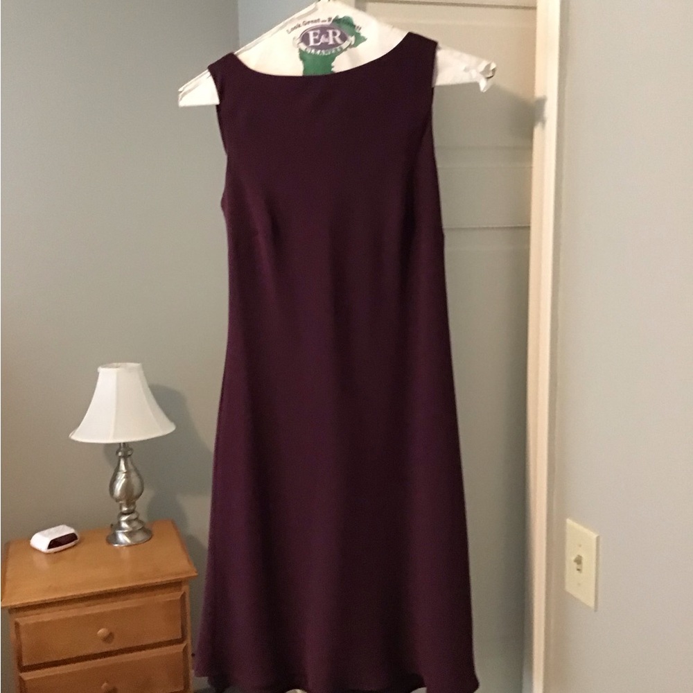 Slightly below the new plum colored dress.